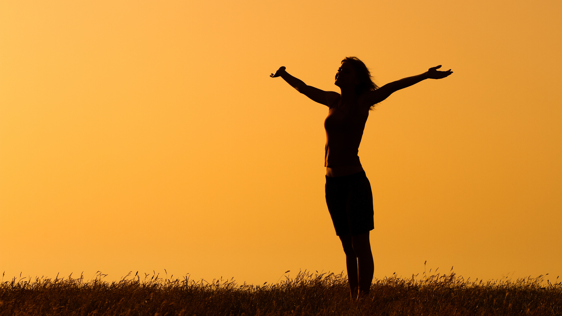 Woman doing yoga and self reflecting during a sunset/sunrise